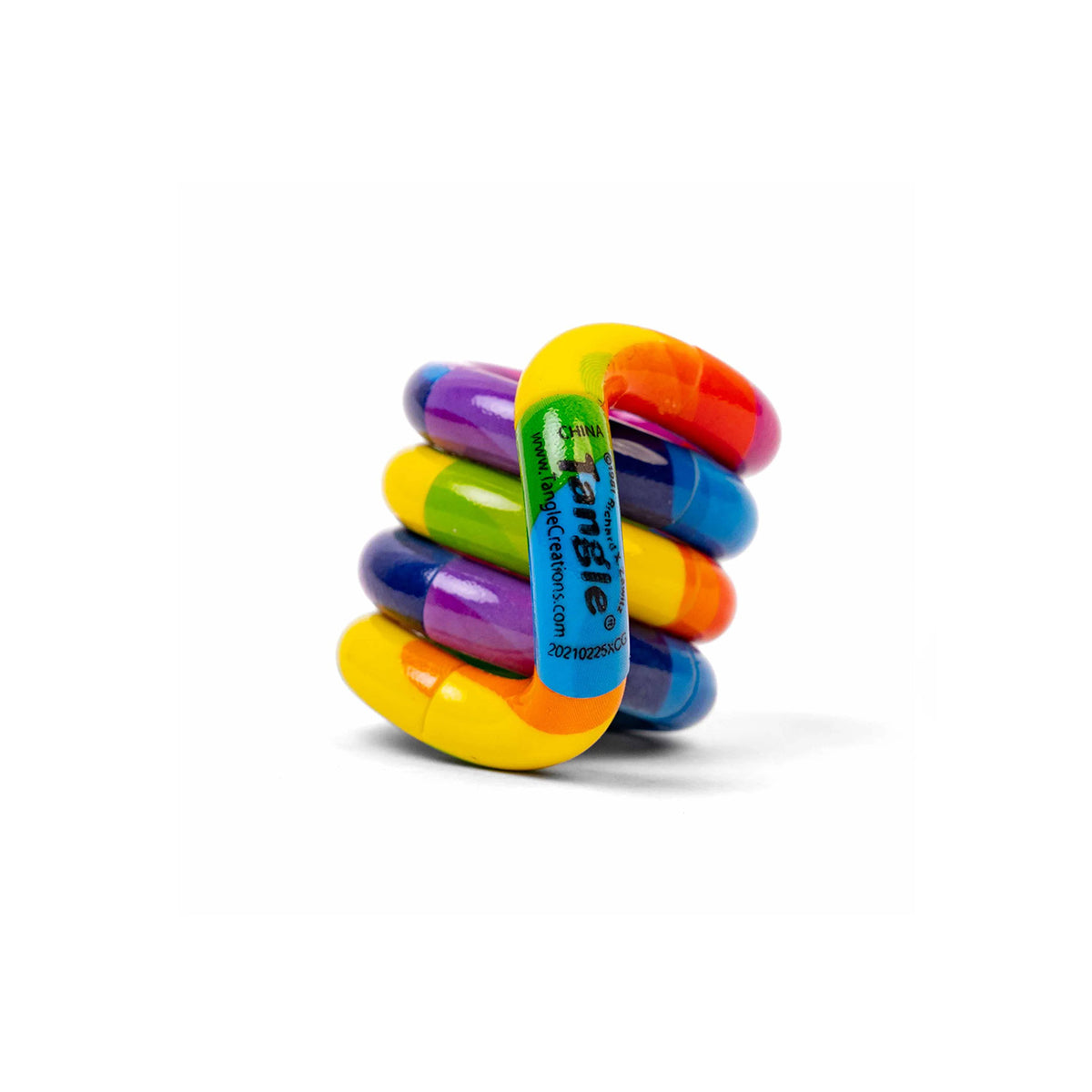 Tangle Jr. Masterpiece Rainbow fidget toy coiled in a compact stack, featuring bold rainbow stripes of red, orange, yellow, green, blue and purple on a white background