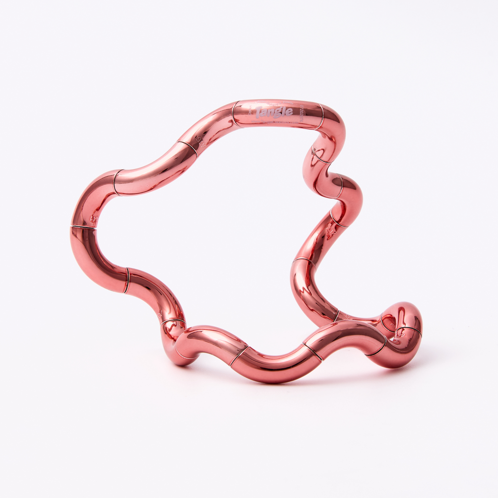 Tangle Jr. Metallic fidget toy in an open extended configuration, featuring a high-gloss metallic coral pink chrome finish on a white background